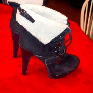 Black velvet heeled boot, with ties, buckles, fur top.